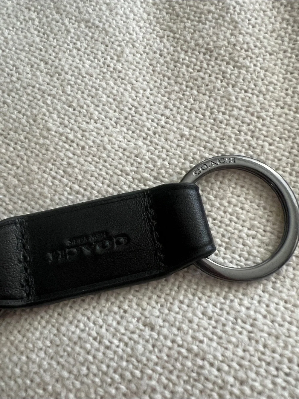 Coach Trigger Snap Key Fob black leather and silver-toned hardware.